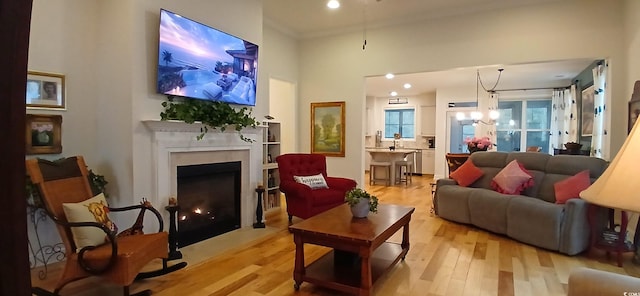 living room featuring a chandelier and light hardwood / wood-style floors