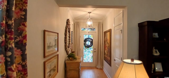 entrance foyer featuring light hardwood / wood-style flooring and ornamental molding