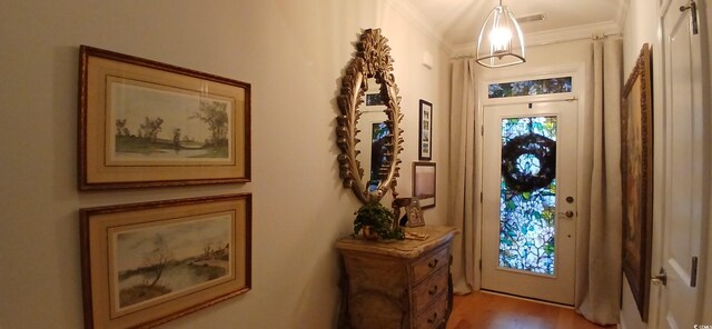 entryway featuring crown molding and wood-type flooring