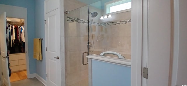 bathroom with a shower with door