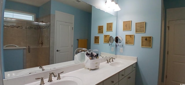 bathroom featuring a shower with door and vanity