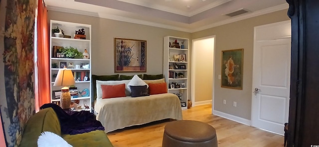 bedroom with ornamental molding and light hardwood / wood-style floors