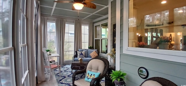 sunroom with coffered ceiling and ceiling fan