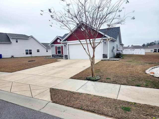 view of front of house featuring a garage and a front lawn