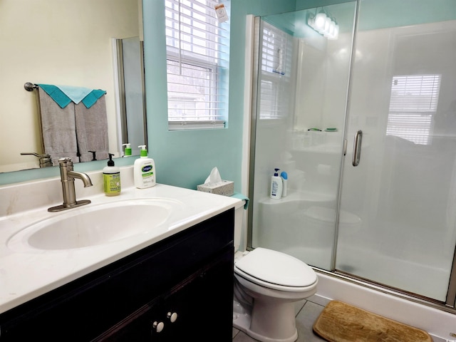 bathroom with vanity, an enclosed shower, and toilet