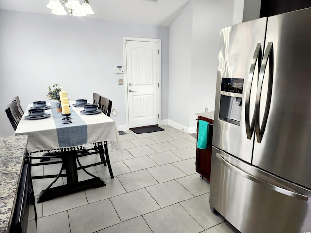 kitchen featuring an inviting chandelier, stainless steel fridge with ice dispenser, and light tile patterned floors