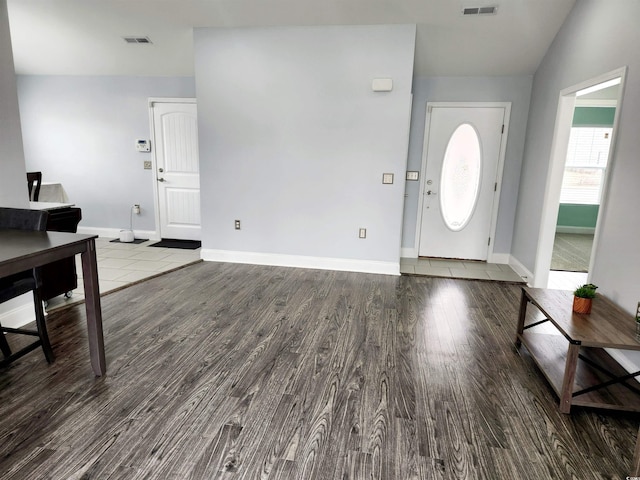 foyer with hardwood / wood-style flooring and vaulted ceiling