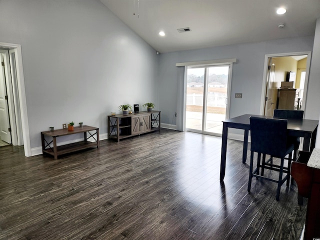 dining space with lofted ceiling and dark hardwood / wood-style floors