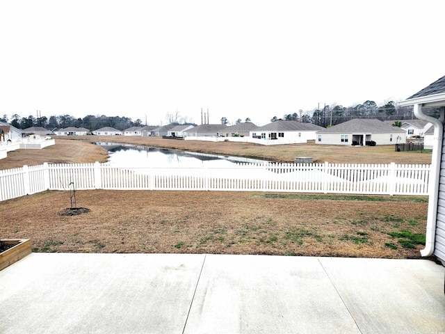 view of yard featuring a patio and a water view