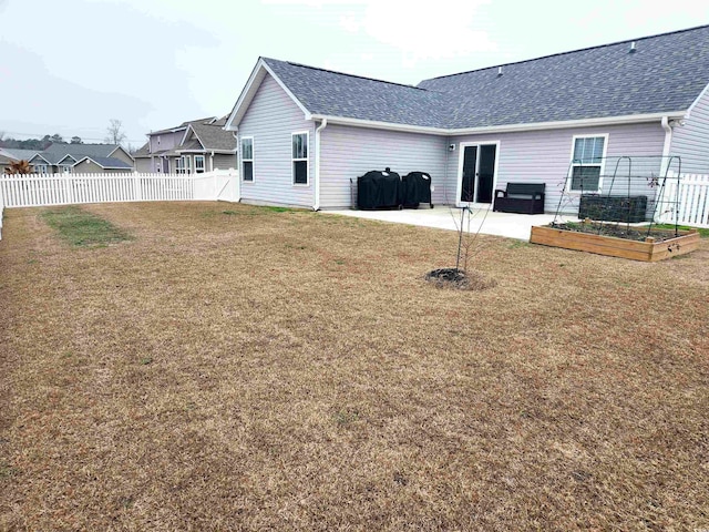 rear view of house with a patio area and a lawn