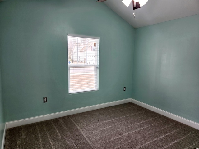 carpeted spare room with vaulted ceiling