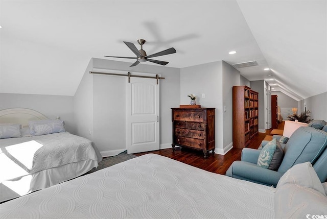 bedroom with dark hardwood / wood-style flooring, vaulted ceiling, a barn door, and ceiling fan