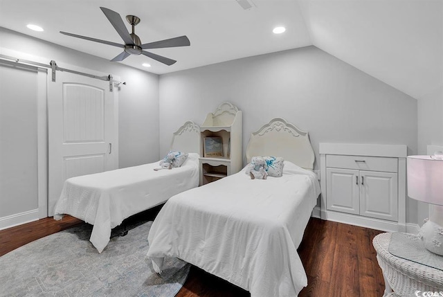 bedroom with a barn door, dark wood-type flooring, lofted ceiling, and ceiling fan