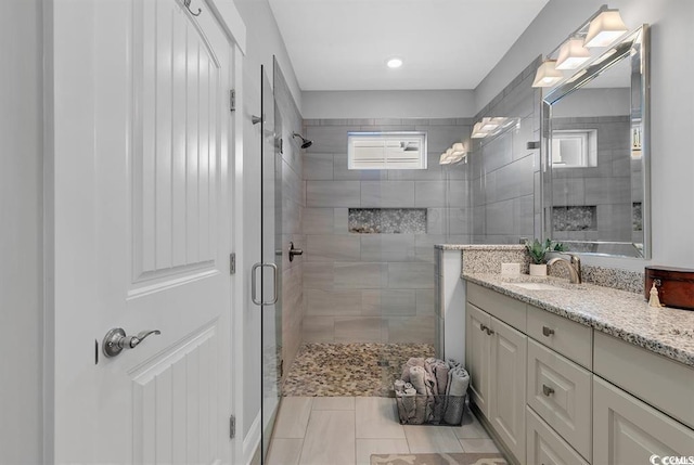 bathroom featuring an enclosed shower and vanity