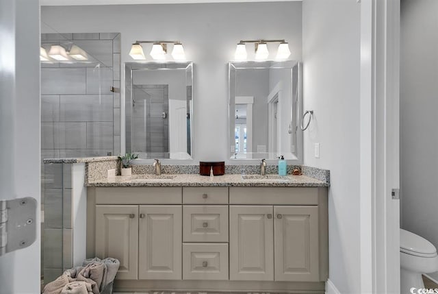 bathroom featuring an enclosed shower, vanity, and toilet