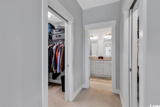 hallway with light colored carpet