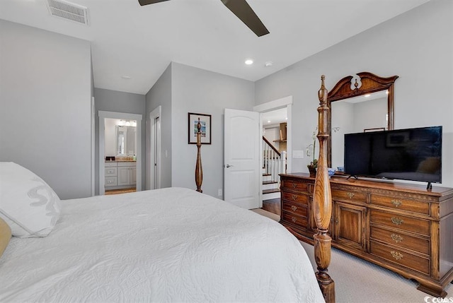 carpeted bedroom with connected bathroom and ceiling fan