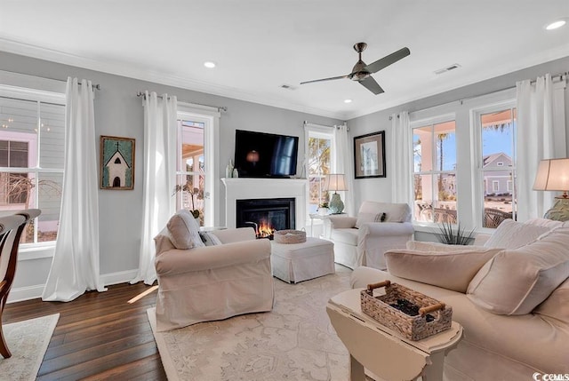 living room with crown molding, ceiling fan, and hardwood / wood-style flooring