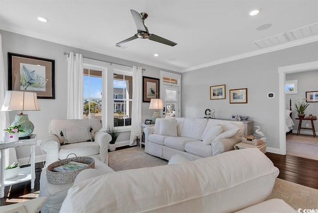 living room with crown molding, ceiling fan, and light hardwood / wood-style floors