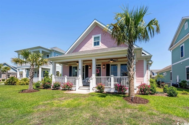 view of front of house with covered porch and a front lawn