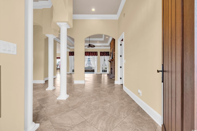 tiled foyer entrance with decorative columns, crown molding, and ceiling fan