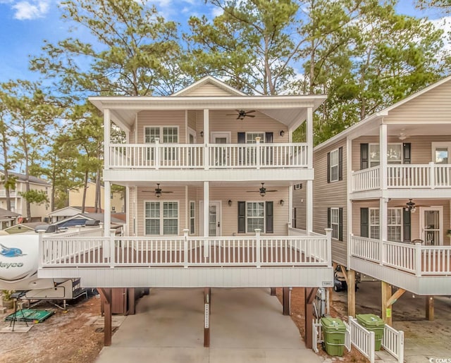 view of front of home with a balcony, a carport, ceiling fan, and concrete driveway