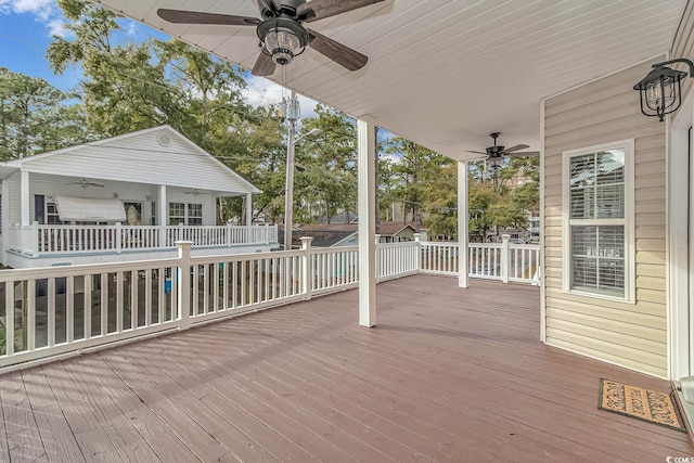 wooden terrace featuring ceiling fan