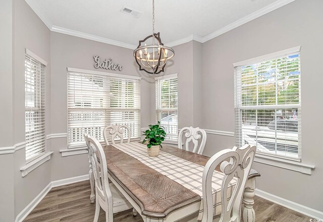 6001-1383 S Kings Hwy, Myrtle Beach, SC 29575 - dining space with crown molding, an inviting chandelier, baseboards, wood finished floors, and visible vents