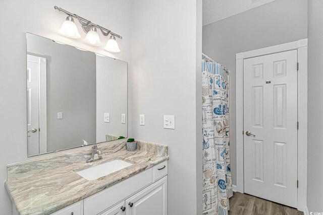 6001-1383 S Kings Hwy, Myrtle Beach, SC 29575 - full bathroom featuring vanity, a shower with shower curtain, and wood finished floors