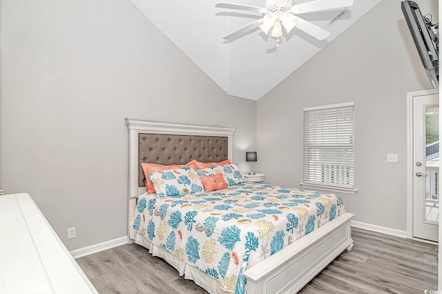 bedroom with lofted ceiling, ceiling fan, wood finished floors, and baseboards