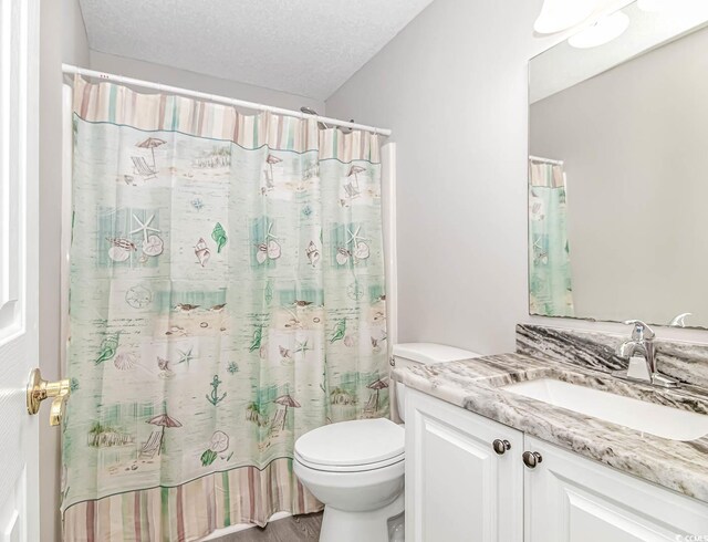 6001-1383 S Kings Hwy, Myrtle Beach, SC 29575 - bathroom with vanity, toilet, a textured ceiling, and a shower with shower curtain