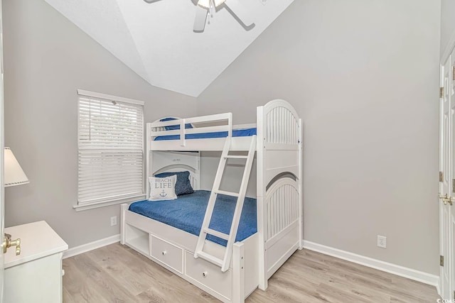 bedroom featuring a ceiling fan, vaulted ceiling, light wood-style flooring, and baseboards