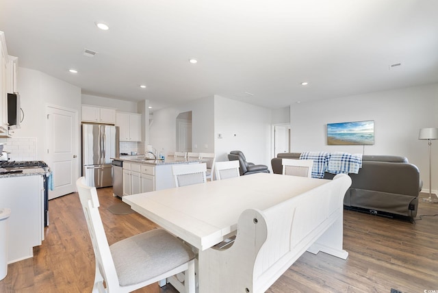 dining room featuring recessed lighting, wood finished floors, and visible vents