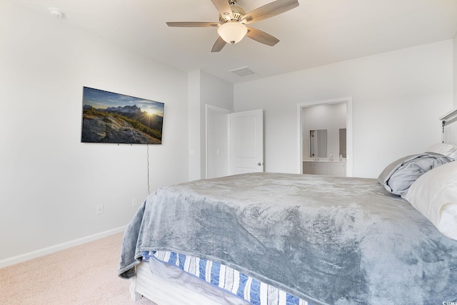 carpeted bedroom with visible vents, a ceiling fan, ensuite bathroom, and baseboards