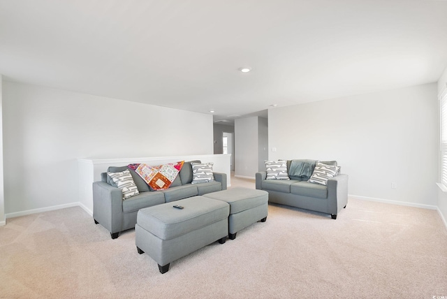 living room with recessed lighting, light colored carpet, and baseboards