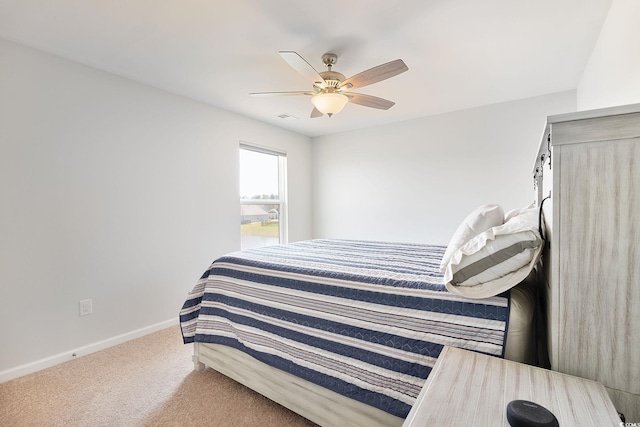 bedroom with ceiling fan, baseboards, and carpet