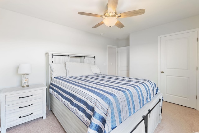 bedroom with light carpet and ceiling fan