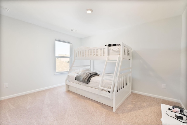 carpeted bedroom featuring baseboards