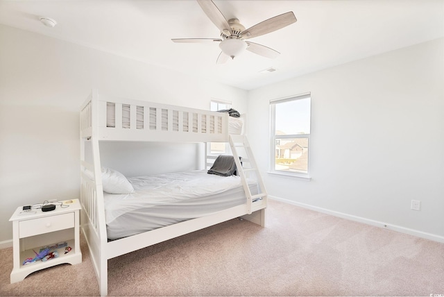 carpeted bedroom featuring a ceiling fan and baseboards