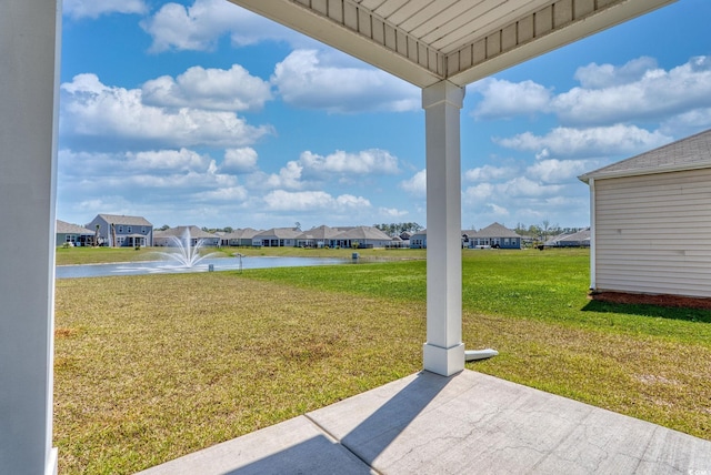 view of yard featuring a residential view and a water view