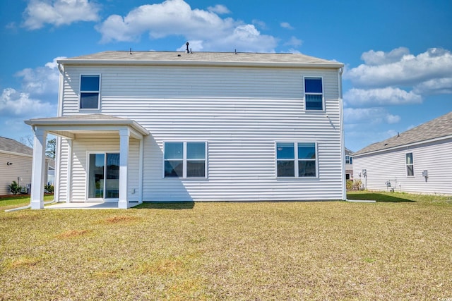 rear view of property with a patio area and a lawn