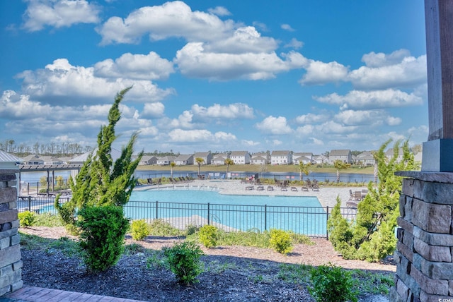 water view featuring a residential view and fence