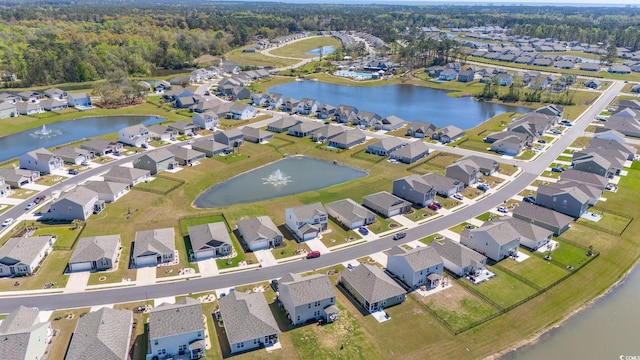 drone / aerial view with a residential view and a water view