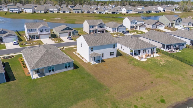 birds eye view of property with a residential view and a water view