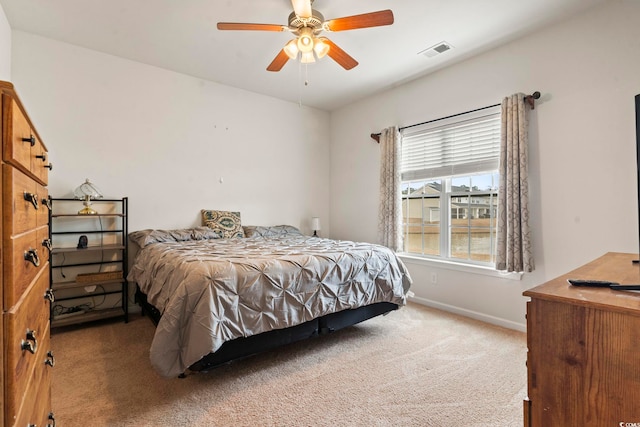 bedroom with visible vents, a ceiling fan, baseboards, and carpet floors