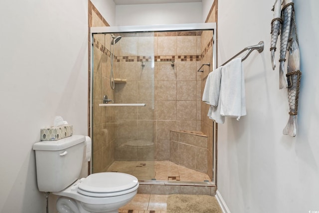 full bathroom with tile patterned floors, a stall shower, and toilet