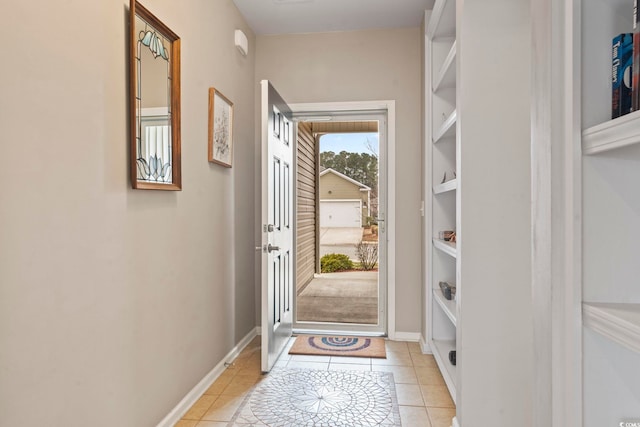 entryway with light tile patterned floors and baseboards