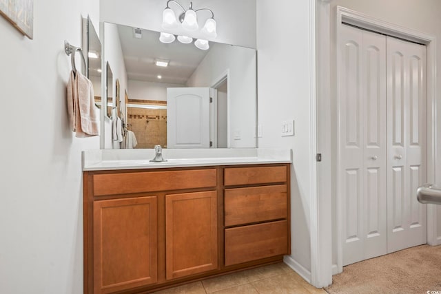 bathroom with a closet, tile patterned floors, vanity, and a tile shower