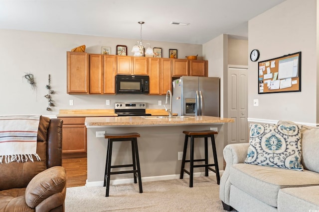 kitchen featuring visible vents, a notable chandelier, open floor plan, appliances with stainless steel finishes, and light countertops