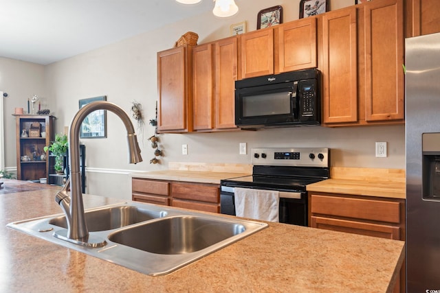 kitchen with a sink, brown cabinets, and stainless steel appliances